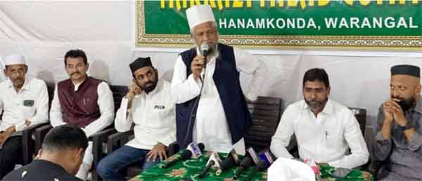 مذہبی رہنما خطاب کرتے ہوئے، شرکاء کی موجودگی میں.